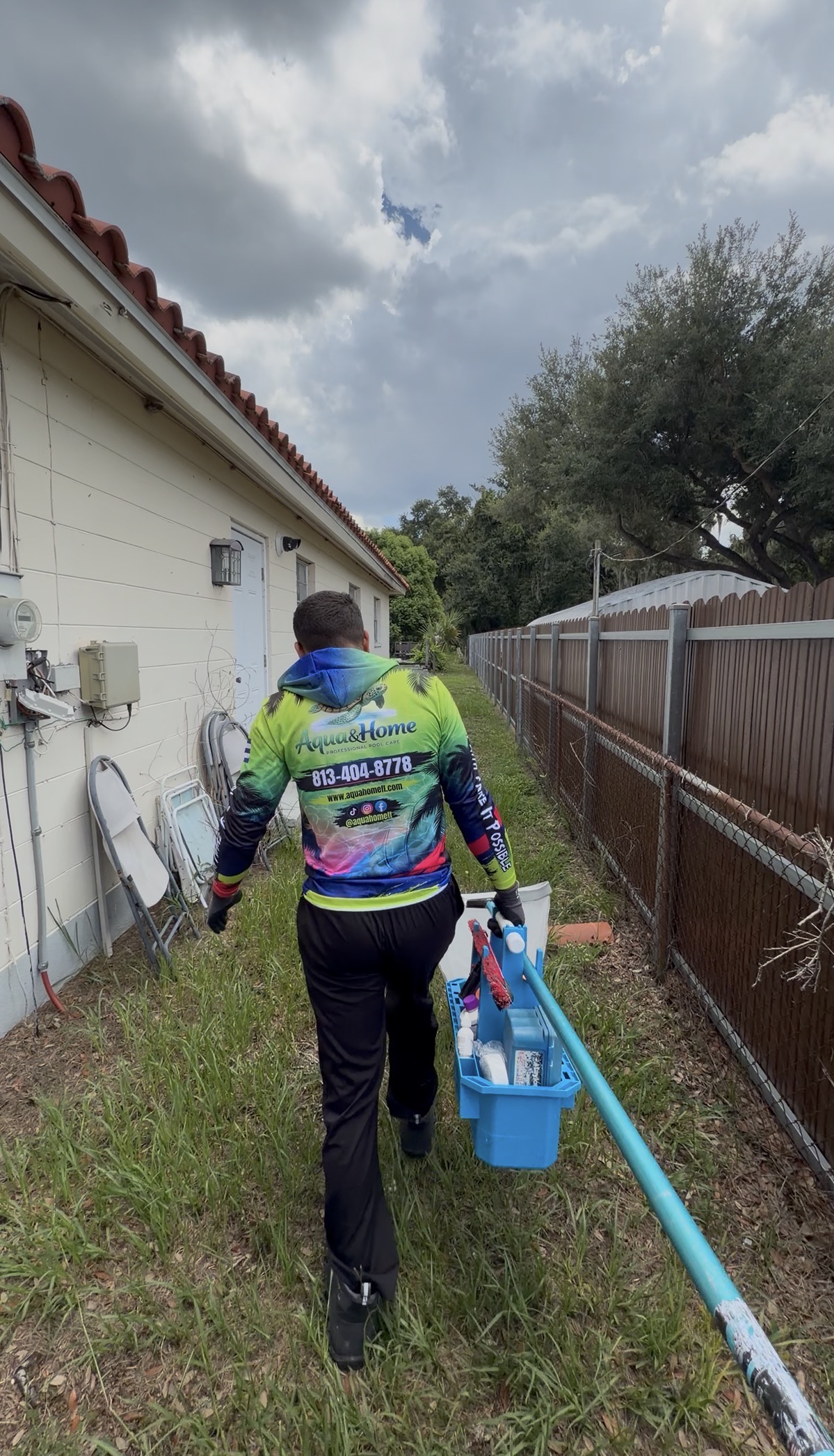 Aqua&Home team member carrying pool care tools on the route